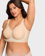 Aafke wireless bra in nude, front view with arm raised