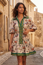 White boho dress with a bird print and bell sleeves, perfect for casual summer outings. 2
