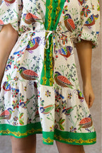 White boho dress with a bird print and bell sleeves, perfect for casual summer outings. 4