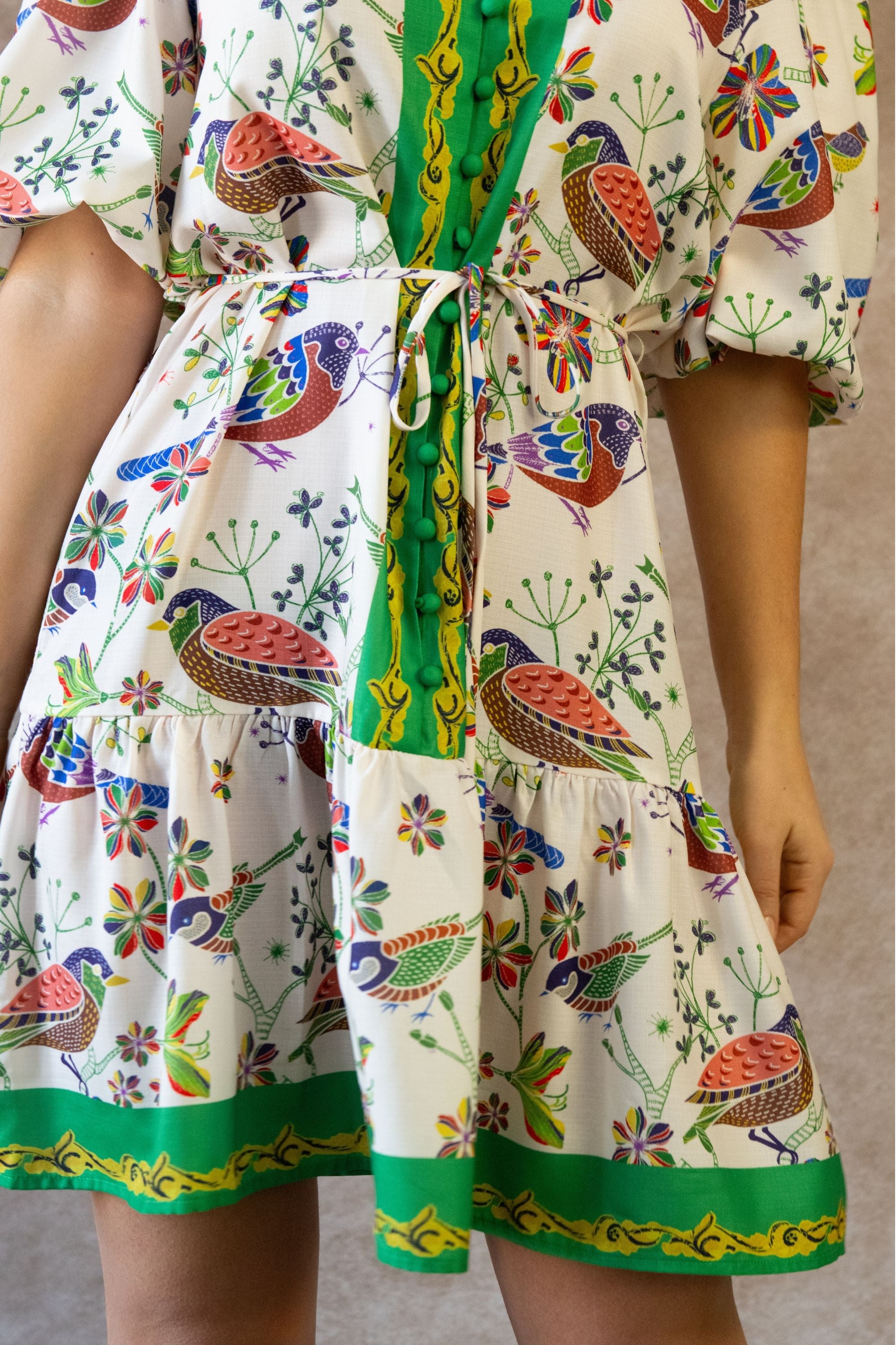 White boho dress with a bird print and bell sleeves, perfect for casual summer outings. 4