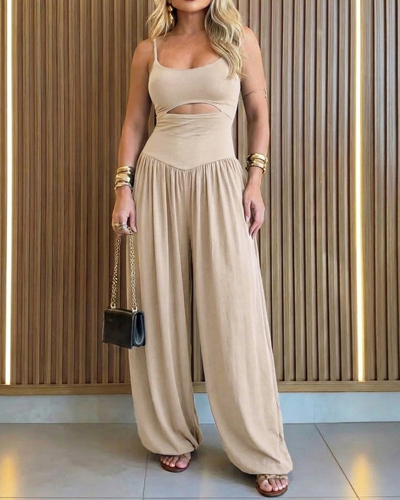 Backless black jumpsuit with cut-out waist and tie-back detail, featuring a stylish lantern silhouette. 10