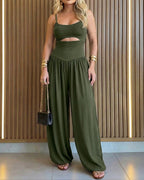 Backless black jumpsuit with cut-out waist and tie-back detail, featuring a stylish lantern silhouette. 11