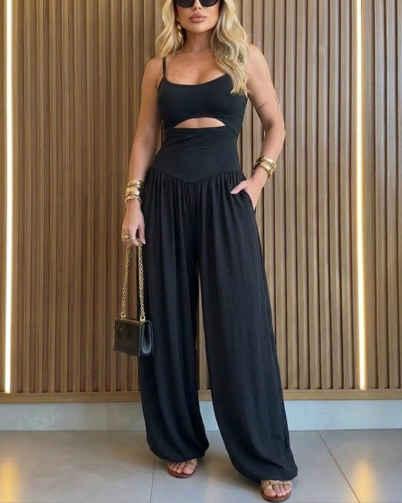 Backless black jumpsuit with cut-out waist and tie-back detail, featuring a stylish lantern silhouette. 2