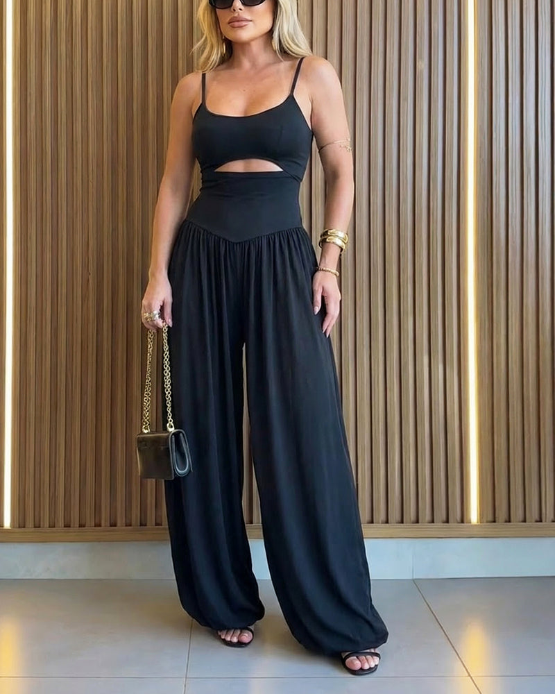 Backless black jumpsuit with cut-out waist and tie-back detail, featuring a stylish lantern silhouette. 5