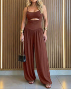 Backless black jumpsuit with cut-out waist and tie-back detail, featuring a stylish lantern silhouette. 9