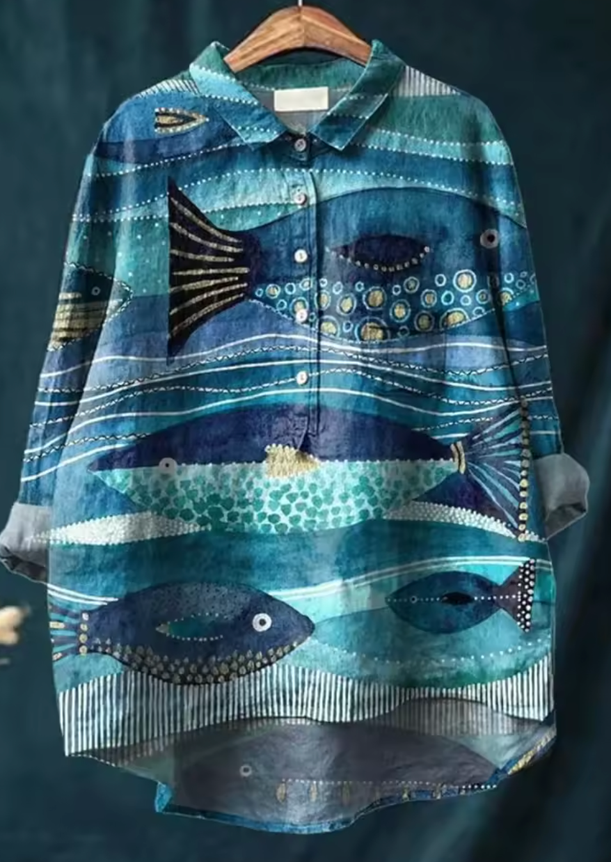 Light blue floral linen blouse with a relaxed fit and short sleeves. 2