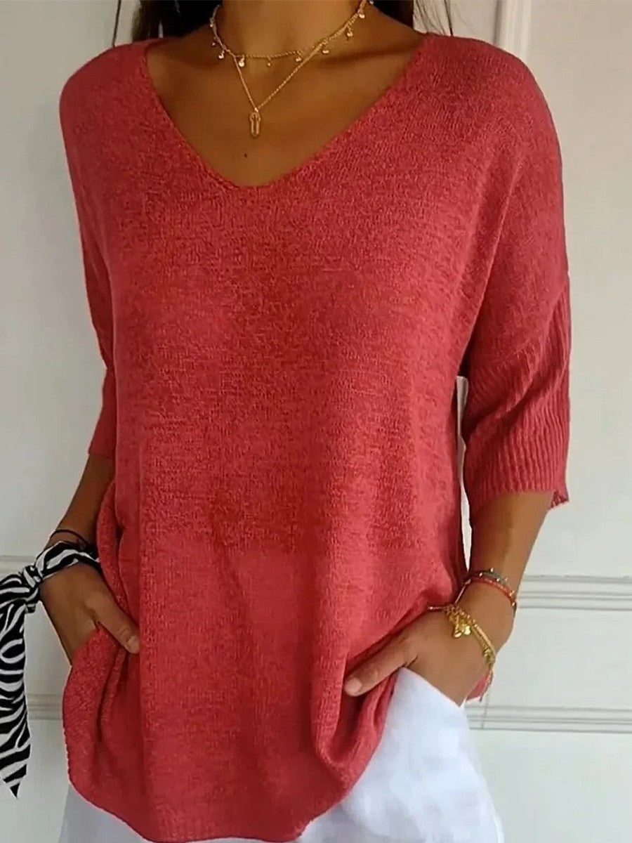 Loose knit V-neck top for women with three-quarter sleeves.