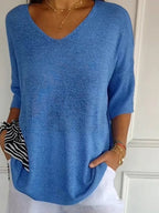 Loose knit V-neck top for women with three-quarter sleeves.