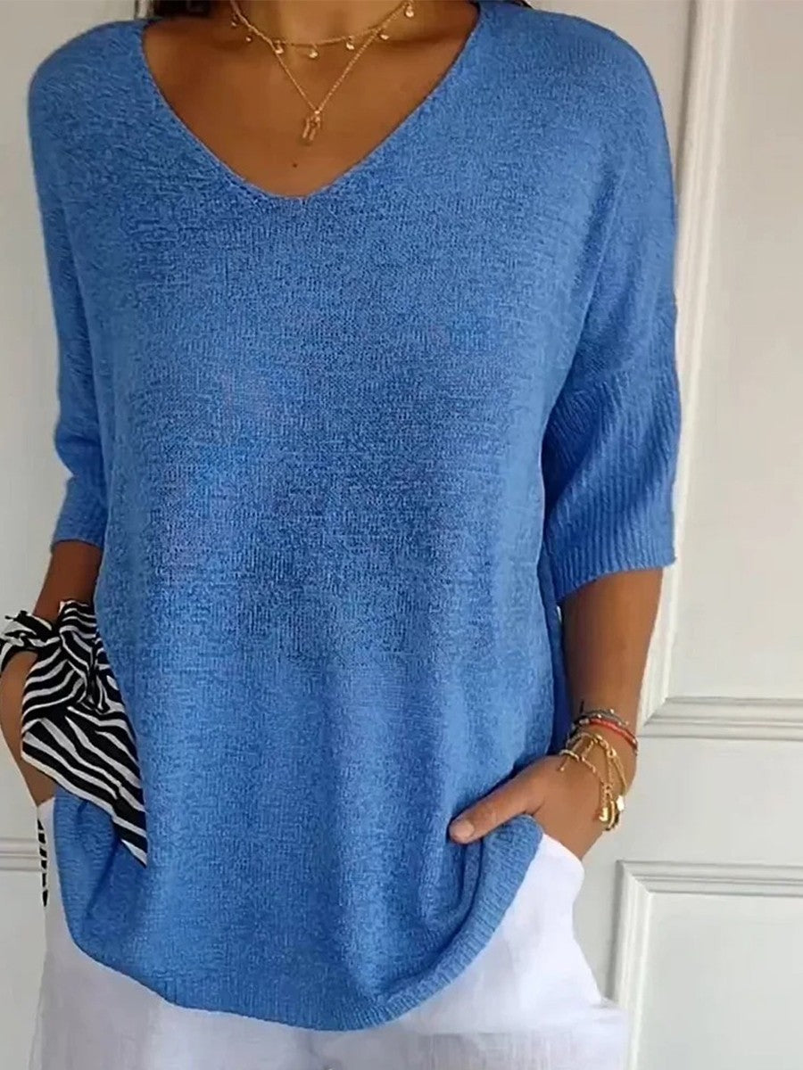 Loose knit V-neck top for women with three-quarter sleeves.
