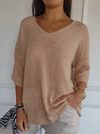 Loose knit V-neck top for women with three-quarter sleeves.