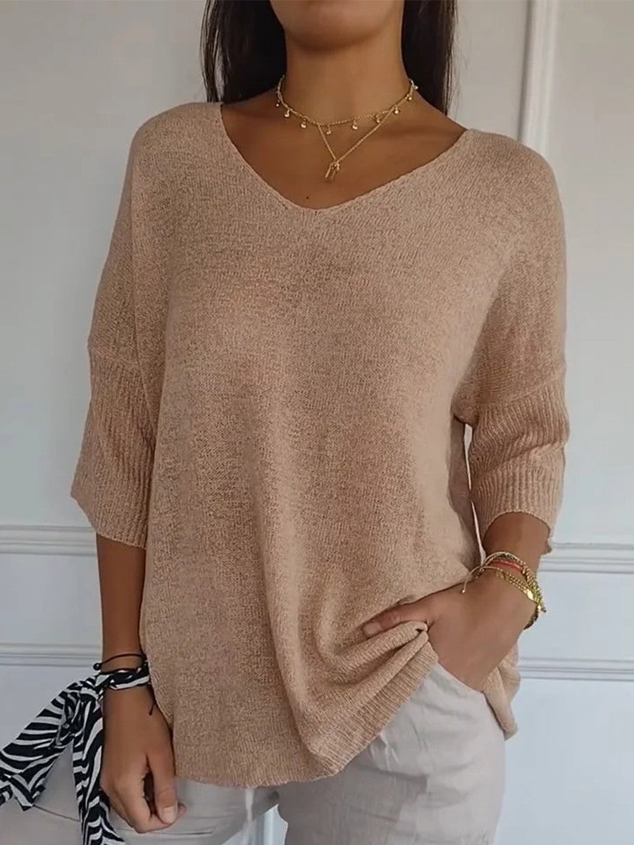 Loose knit V-neck top for women with three-quarter sleeves.