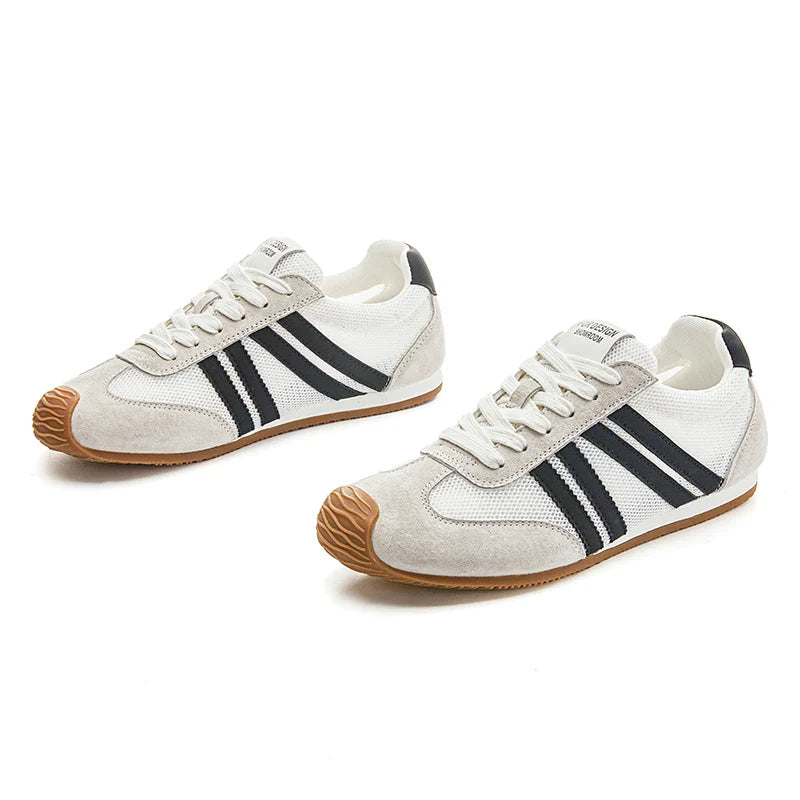 Lightweight black running sneakers with a sleek, modern design and breathable mesh upper. 2