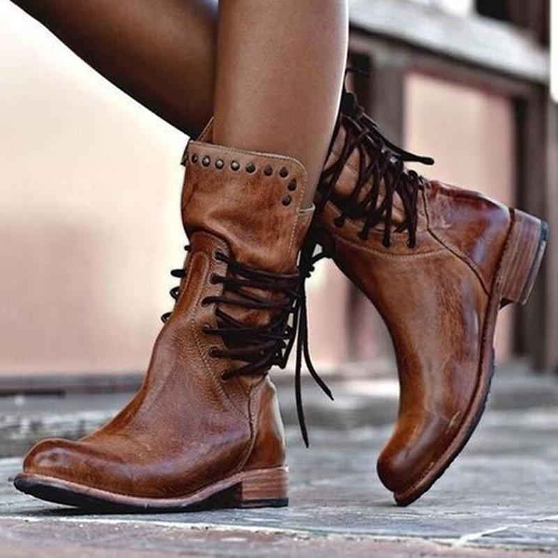 Stylish black ankle boots with a sleek design and subtle embellishments. 0