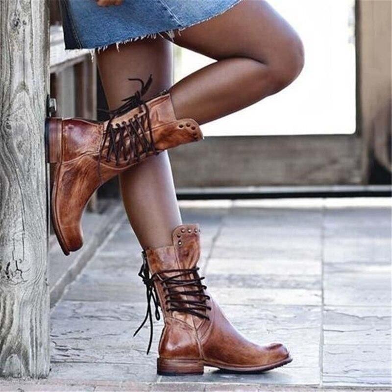 Stylish black ankle boots with a sleek design and subtle embellishments. 2