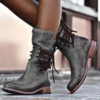 Stylish black ankle boots with a sleek design and subtle embellishments. 6