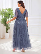 Plus size evening gown with a deep V-neck and a sequinned leaf pattern over tulle.