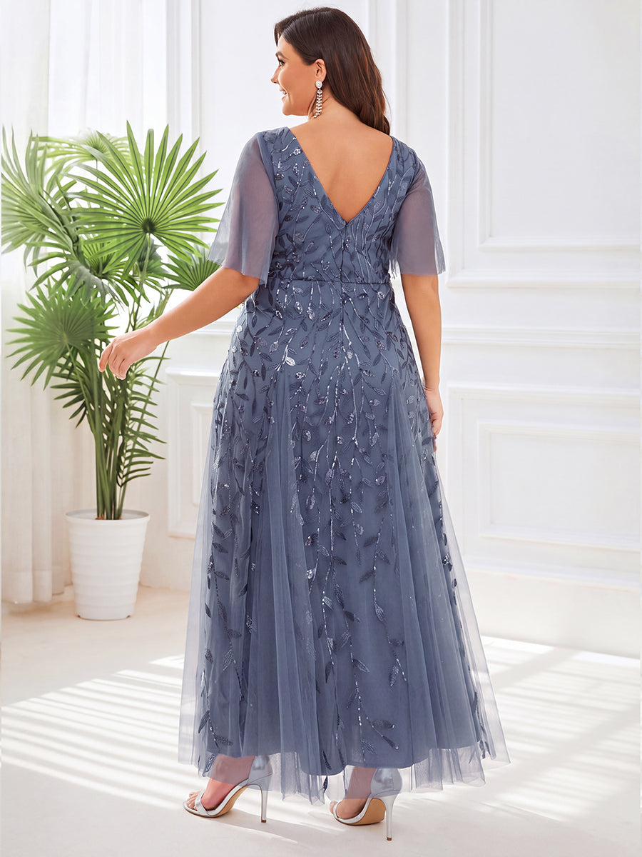 Plus size evening gown with a deep V-neck and a sequinned leaf pattern over tulle.