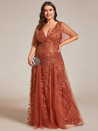 Plus size evening gown with a deep V-neck and a sequinned leaf pattern over tulle.