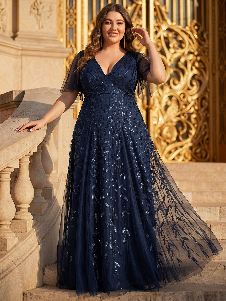 Plus size evening gown with a deep V-neck and a sequinned leaf pattern over tulle.