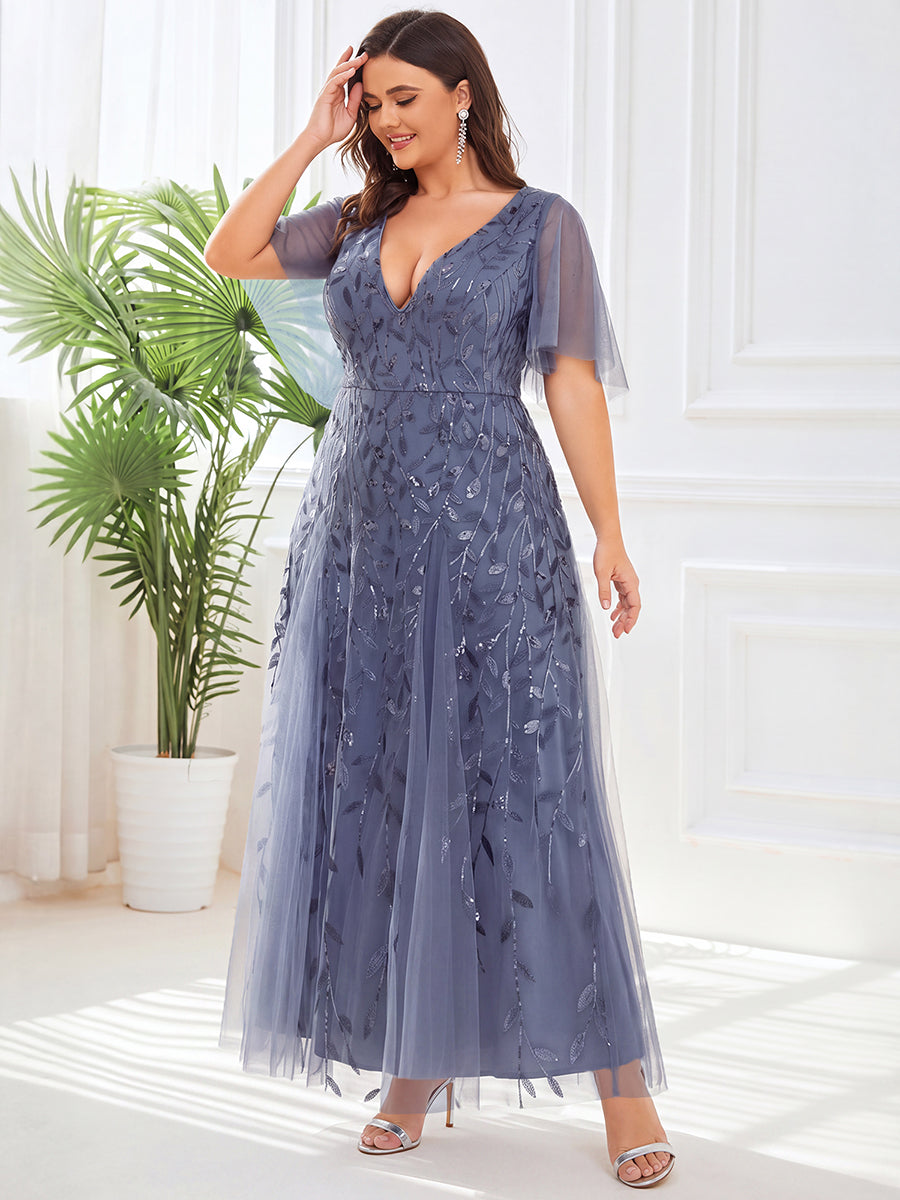 Plus size evening gown with a deep V-neck and a sequinned leaf pattern over tulle.