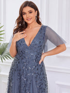 Plus size evening gown with a deep V-neck and a sequinned leaf pattern over tulle.