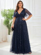 Plus size evening gown with a deep V-neck and a sequinned leaf pattern over tulle.
