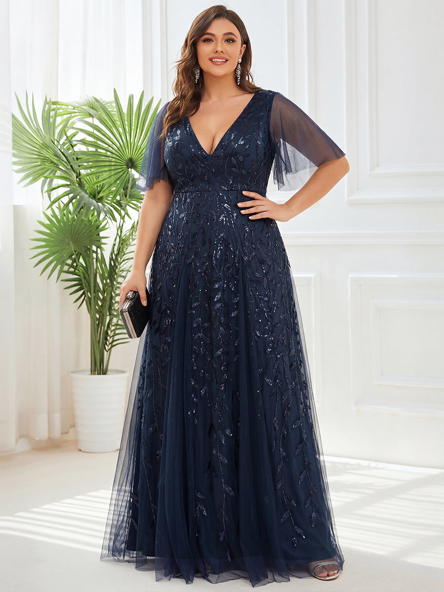 Plus size evening gown with a deep V-neck and a sequinned leaf pattern over tulle.