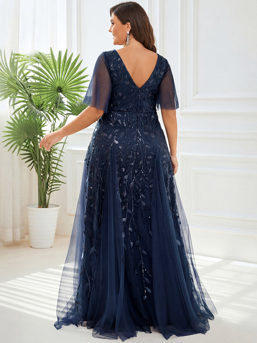 Back view of the navy plus size evening gown with a deep V-back and tulle overlay.