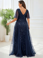 Back view of the navy plus size evening gown with a deep V-back and tulle overlay.