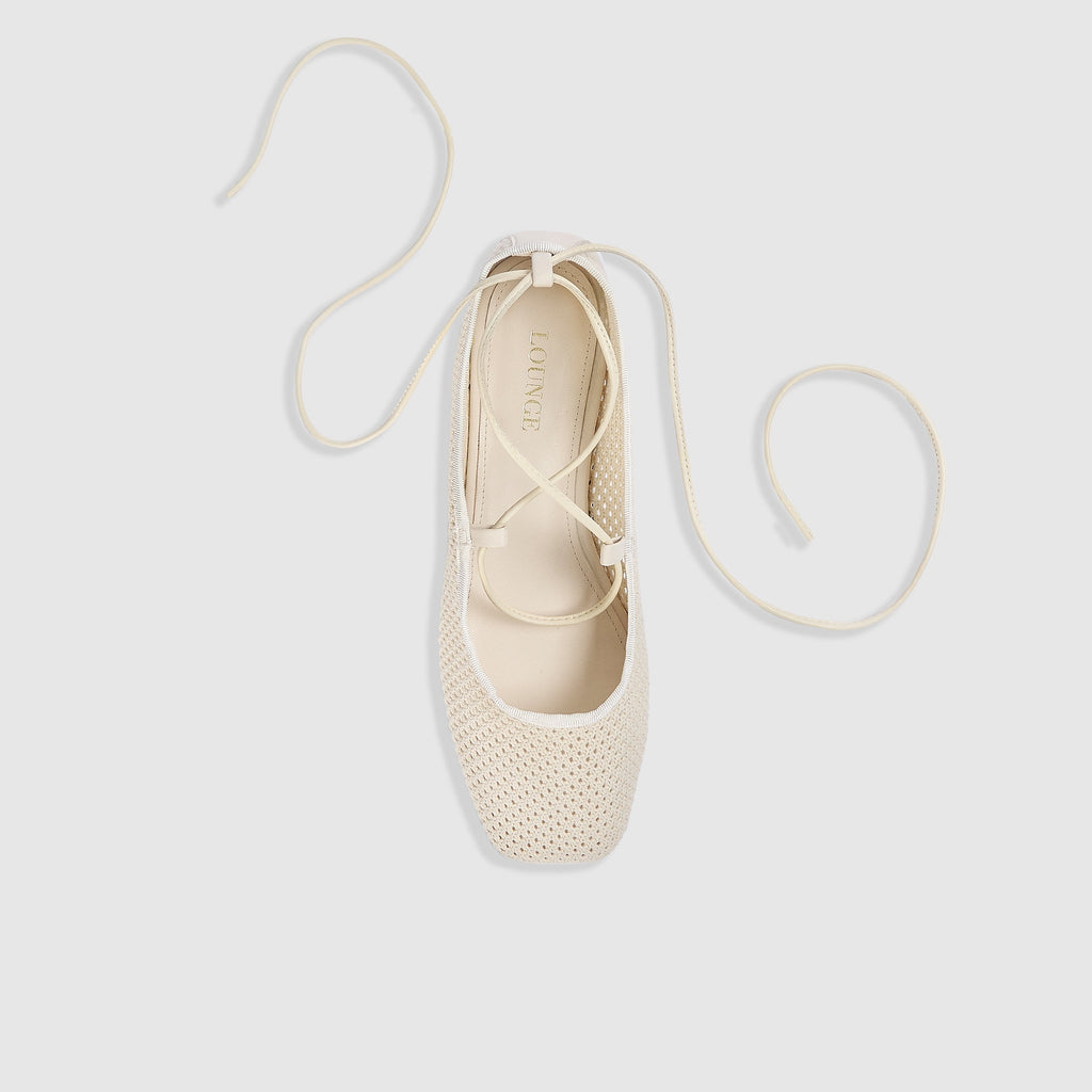 Off-white ballet flats with ankle tie detail and soft-square toe design. 1