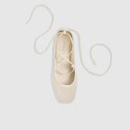 Off-white ballet flats with ankle tie detail and soft-square toe design. 1