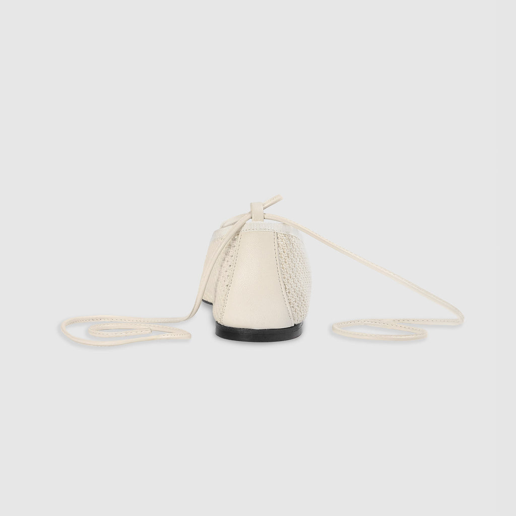Off-white ballet flats with ankle tie detail and soft-square toe design. 2