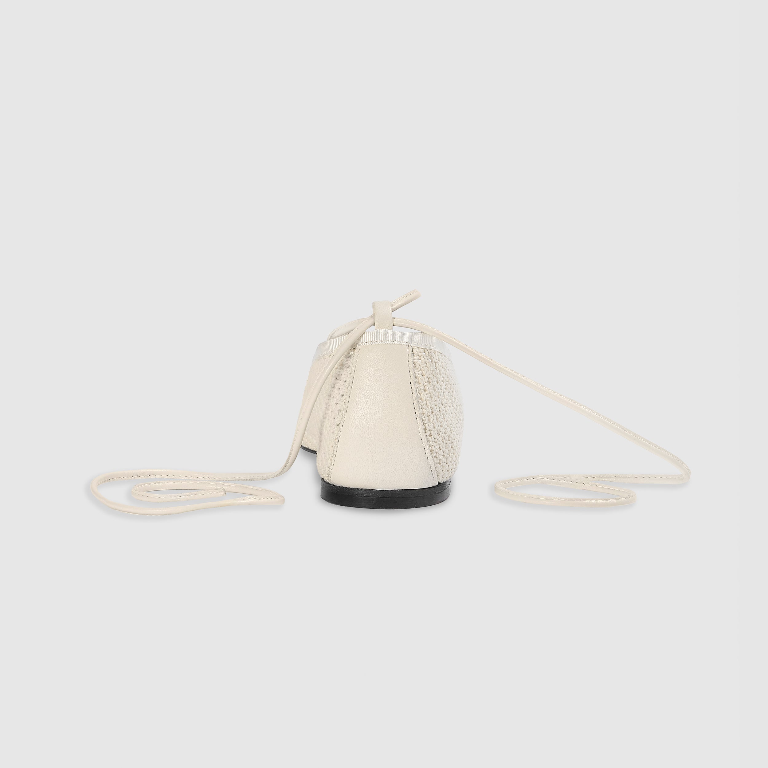 Off-white ballet flats with ankle tie detail and soft-square toe design. 2