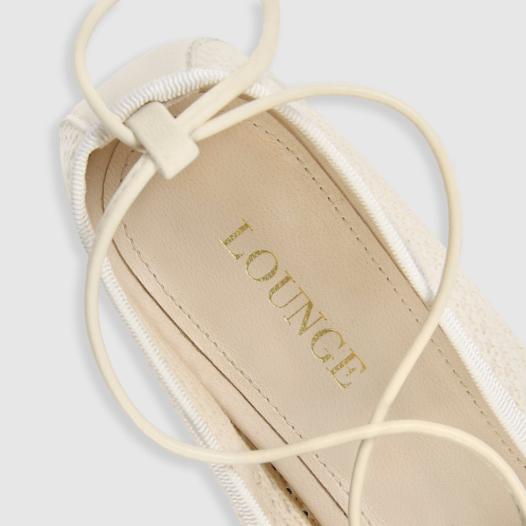 Off-white ballet flats with ankle tie detail and soft-square toe design. 3