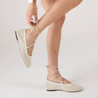 Off-white ballet flats with ankle tie detail and soft-square toe design. 6