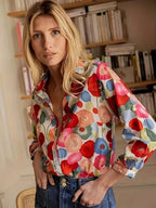 Light blue floral women's shirt in a relaxed fit, featuring short sleeves and a feminine, casual style. 1