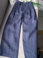 Beige wide-leg pants made from a cotton-linen blend, featuring a relaxed fit for comfort and breathability. 0