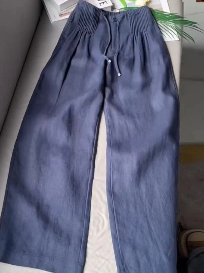 Beige wide-leg pants made from a cotton-linen blend, featuring a relaxed fit for comfort and breathability. 0