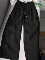 Beige wide-leg pants made from a cotton-linen blend, featuring a relaxed fit for comfort and breathability. 1