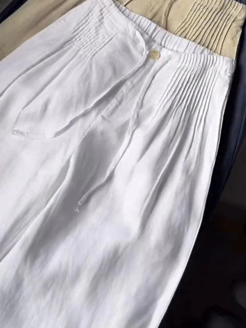 Beige wide-leg pants made from a cotton-linen blend, featuring a relaxed fit for comfort and breathability. 2