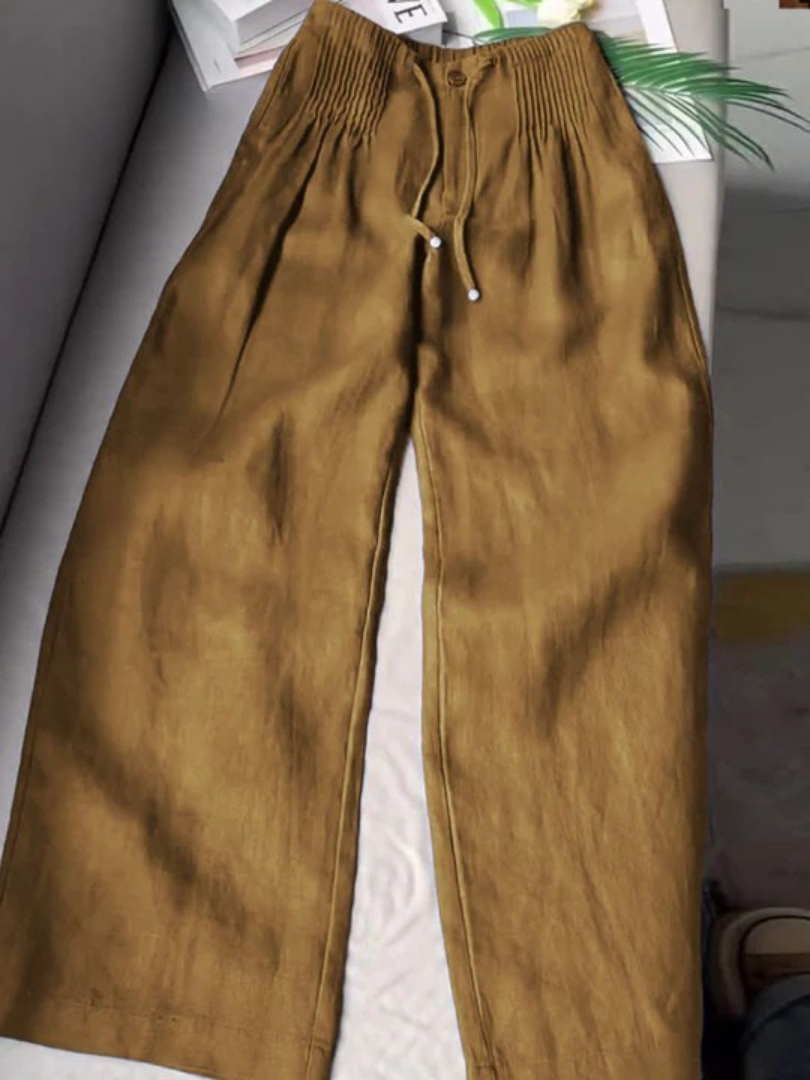 Beige wide-leg pants made from a cotton-linen blend, featuring a relaxed fit for comfort and breathability. 4