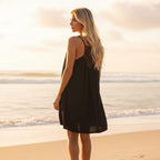 Lightweight mini beach cover-up dress in soft white, featuring a relaxed O-neckline and sleeveless design. 1