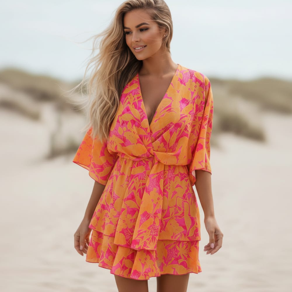Boho floral mini dress in soft pastel colors with ruffle details and batwing sleeves. 0