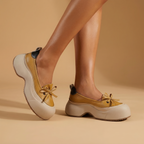 Clara cushioned support shoes in soft beige vegan leather, featuring a sleek and minimalist design for everyday wear. 4