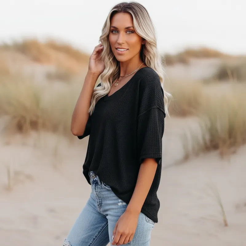 Clara oversized short sleeve V-neck shirt in light blue, made from a soft cotton-polyester blend. 1
