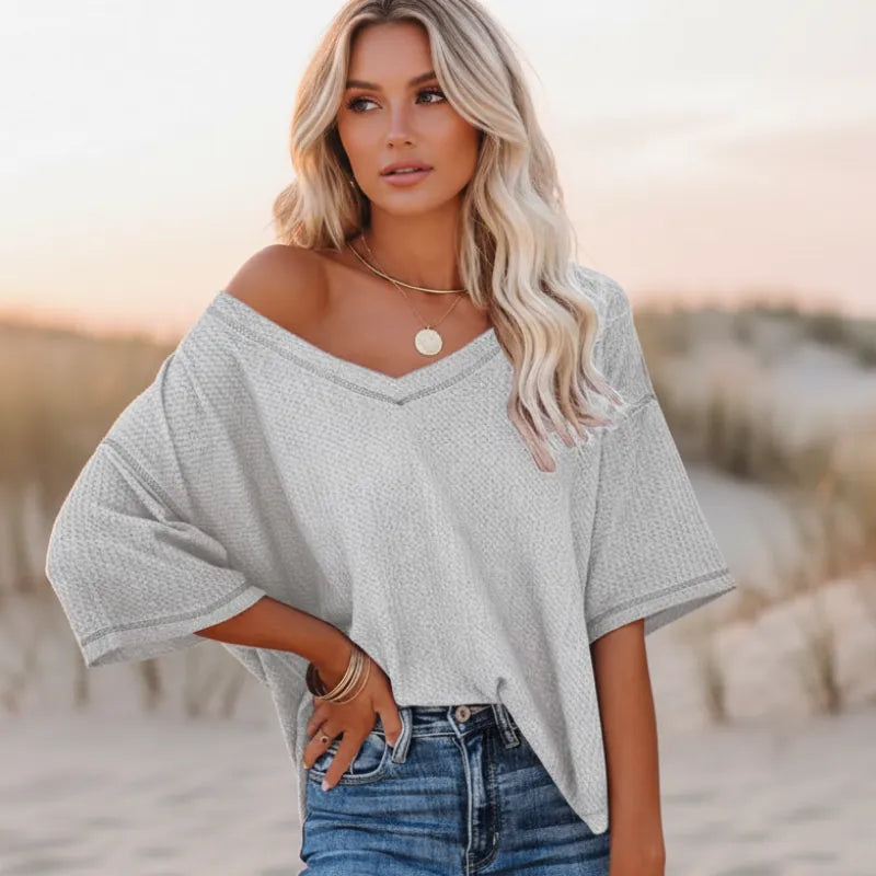 Clara oversized short sleeve V-neck shirt in light blue, made from a soft cotton-polyester blend. 6