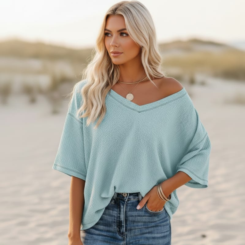 Clara oversized short sleeve V-neck shirt in light blue, made from a soft cotton-polyester blend. 7