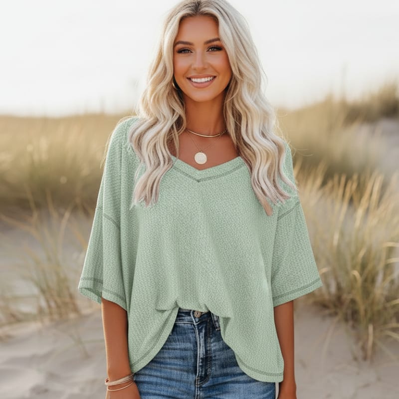 Clara oversized short sleeve V-neck shirt in light blue, made from a soft cotton-polyester blend. 8