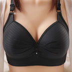 Plus size bra in soft blush pink, featuring adjustable straps and a non-wired, comfortable design. 0