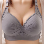 Plus size bra in soft blush pink, featuring adjustable straps and a non-wired, comfortable design. 2